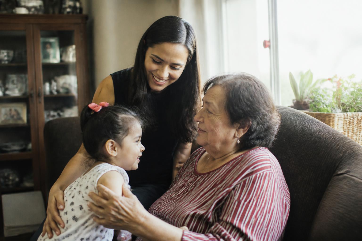 Three generations of a family sharing a tender moment at home